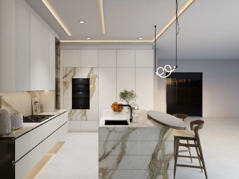 Modern luxury kitchen featuring a marble island, integrated appliances, handleless cabinetry, and sophisticated recessed ceiling lighting.