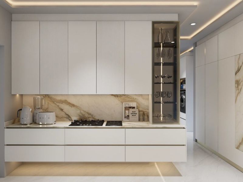 Modern luxury kitchen featuring sleek white cabinetry, marble splashback, integrated appliances, and sophisticated recessed ceiling lighting.