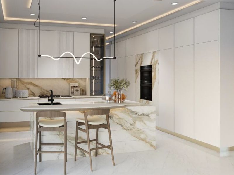 Modern luxury kitchen featuring high-end marble island, integrated cabinetry, built-in double ovens, and sophisticated recessed lighting.