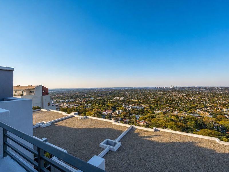 Elevated panoramic view overlooking the surrounding suburban landscape and cityscape from an apartment balcony.