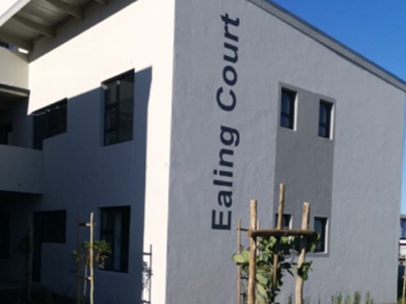 Exterior view of the Ealing Court apartment building, featuring a clean painted facade and modern window frames.