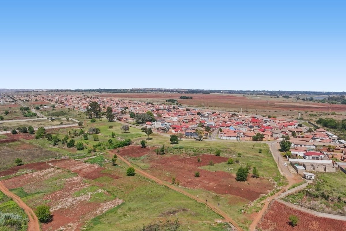 An aerial view showing the surrounding landscape and residential development in the area.