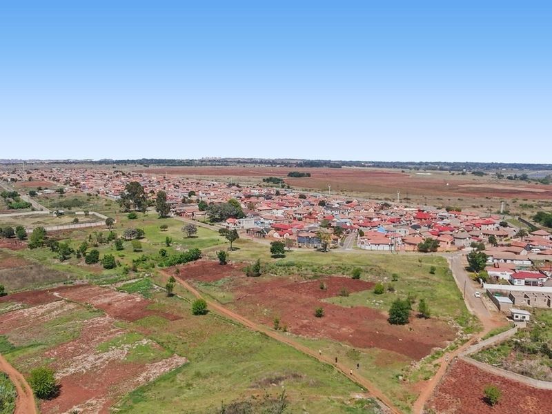 An aerial view showing the surrounding landscape and residential development in the area.