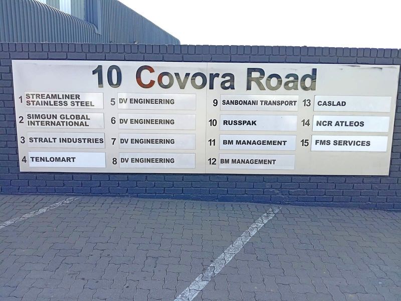 Exterior view of the business park entrance featuring a directory sign for multiple tenants at 10 Covora Road.