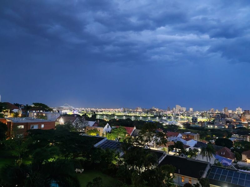 Elevated night view overlooking the surrounding residential neighborhood and city skyline.