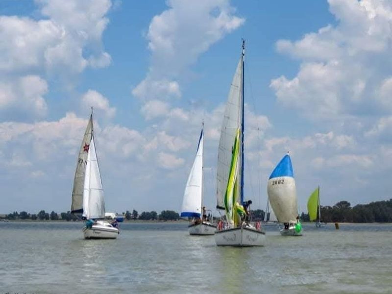 A scenic view of sailboats on the water, highlighting the recreational lifestyle potential of the surrounding area.