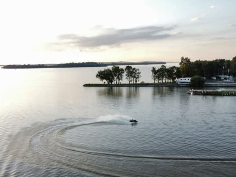 A scenic aerial view of the expansive lake and surrounding landscape, highlighting the tranquil waterfront setting.