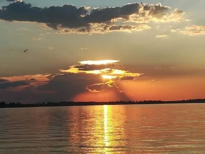 A scenic sunset view over the water, highlighting the natural landscape surrounding the property.