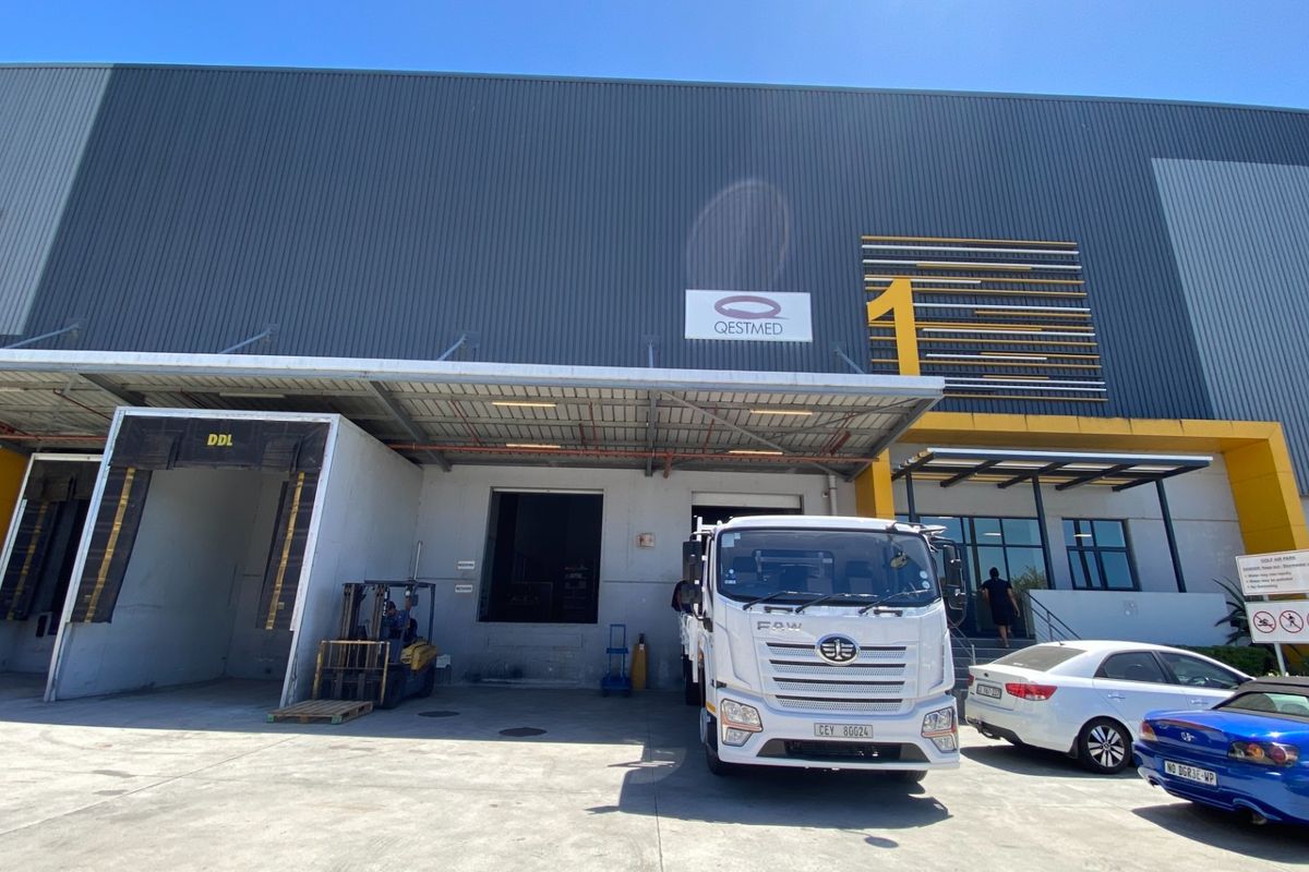 Front elevation of an industrial warehouse facility featuring a loading dock, metal cladding, and a covered entrance area.