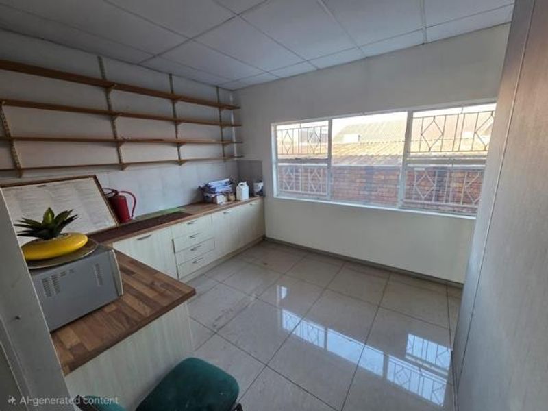 Functional office space featuring built-in cabinetry, wall-mounted shelving, tiled flooring, and large windows with security bars.