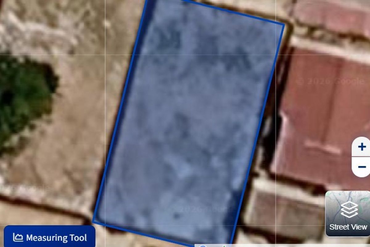 An aerial view showing the boundaries of the vacant residential land plot.