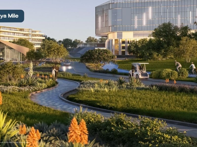 A high-quality architectural rendering of a landscaped residential estate featuring manicured green spaces, paved walking paths, and a modern water feature.