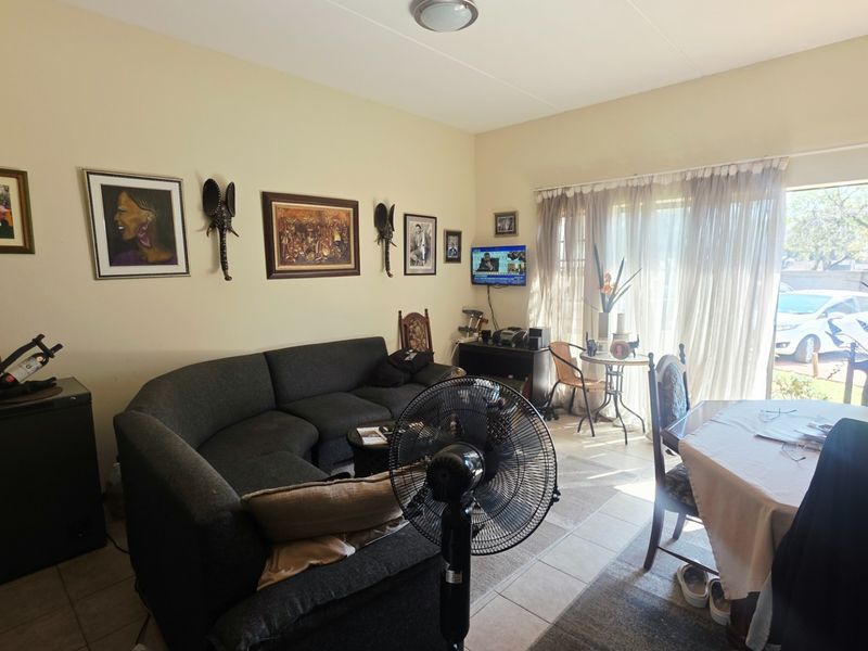Open plan living and dining area featuring tiled flooring and a sliding glass door providing access to the exterior.
