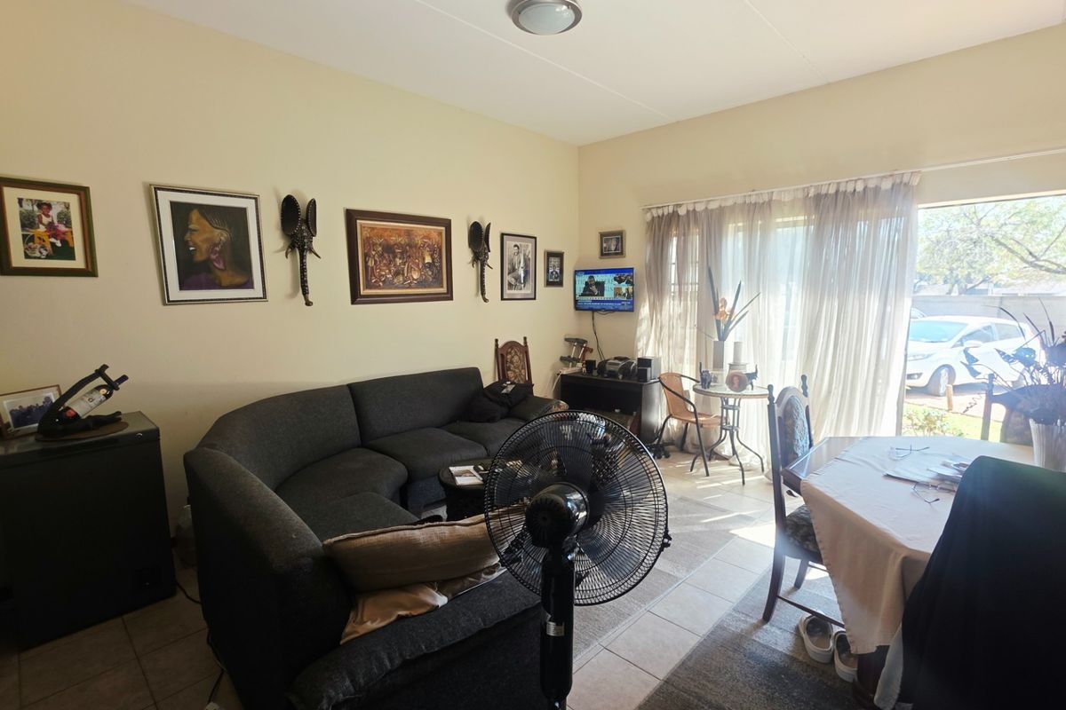 Open plan living and dining area featuring tiled flooring and a sliding glass door providing access to the exterior.