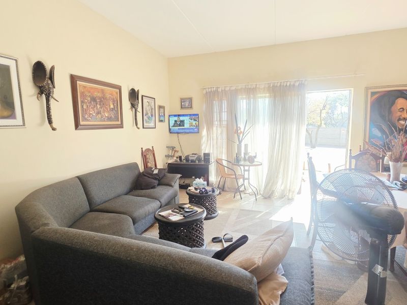 Open plan living area featuring tiled flooring and a sliding glass door providing access to the outdoor space.