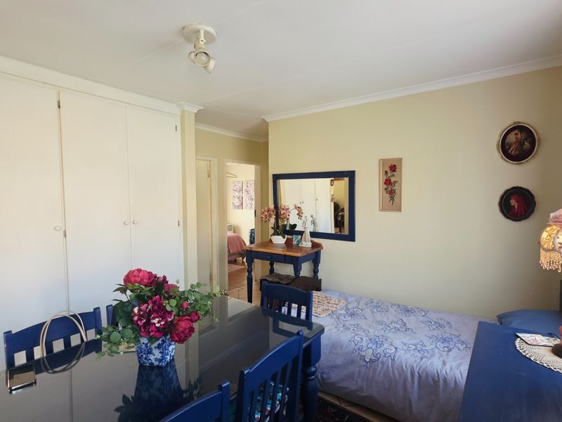 A bedroom featuring built-in cupboards and coved cornicing, offering a functional space with neutral wall finishes.