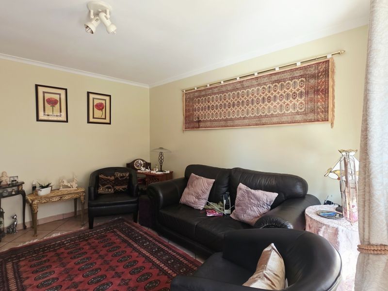A comfortable living room featuring tiled flooring and neutral wall tones, providing a functional and inviting space for relaxation.