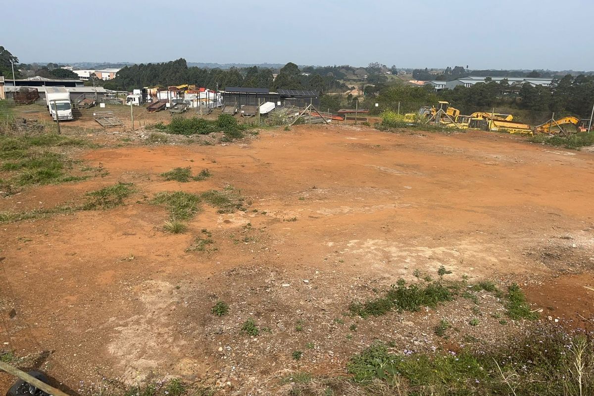 An expansive, cleared agricultural land plot featuring open terrain and perimeter wire fencing, suitable for various development or agricultural purposes.
