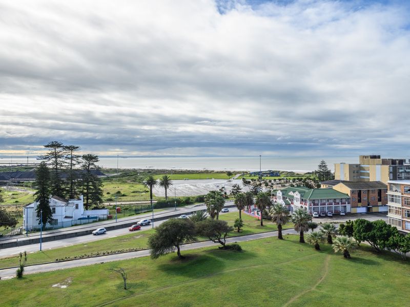 Elevated coastal view overlooking the surrounding neighborhood, green spaces, and the distant ocean horizon.