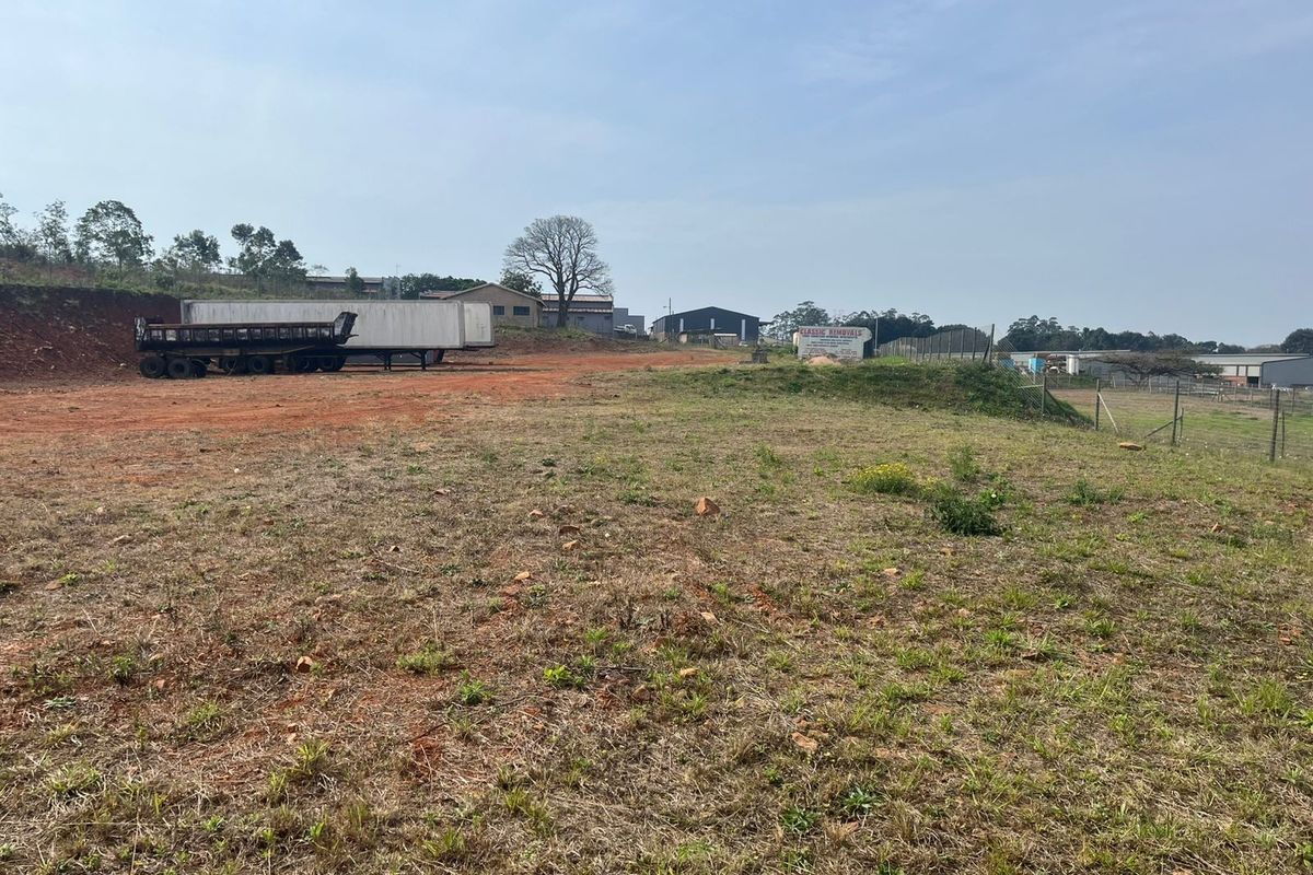 An expansive, open agricultural land plot featuring cleared terrain and perimeter wire fencing, suitable for various development or agricultural purposes.