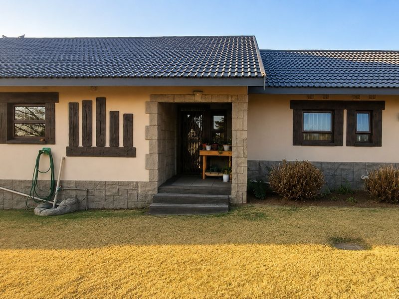 Front elevation of a single-story house featuring a tiled roof, stone cladding accents, and timber-framed windows with a central entrance.