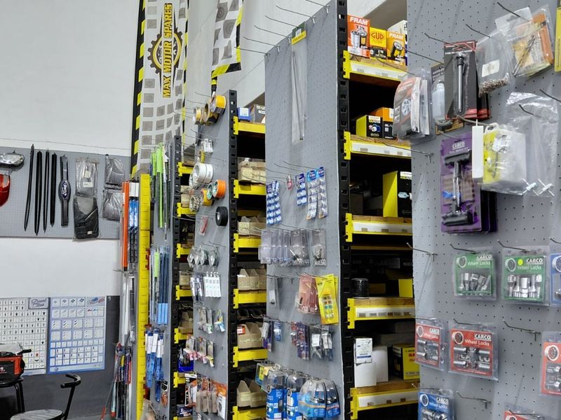 Commercial retail space featuring industrial metal shelving units and pegboard display panels for organized product storage and presentation.