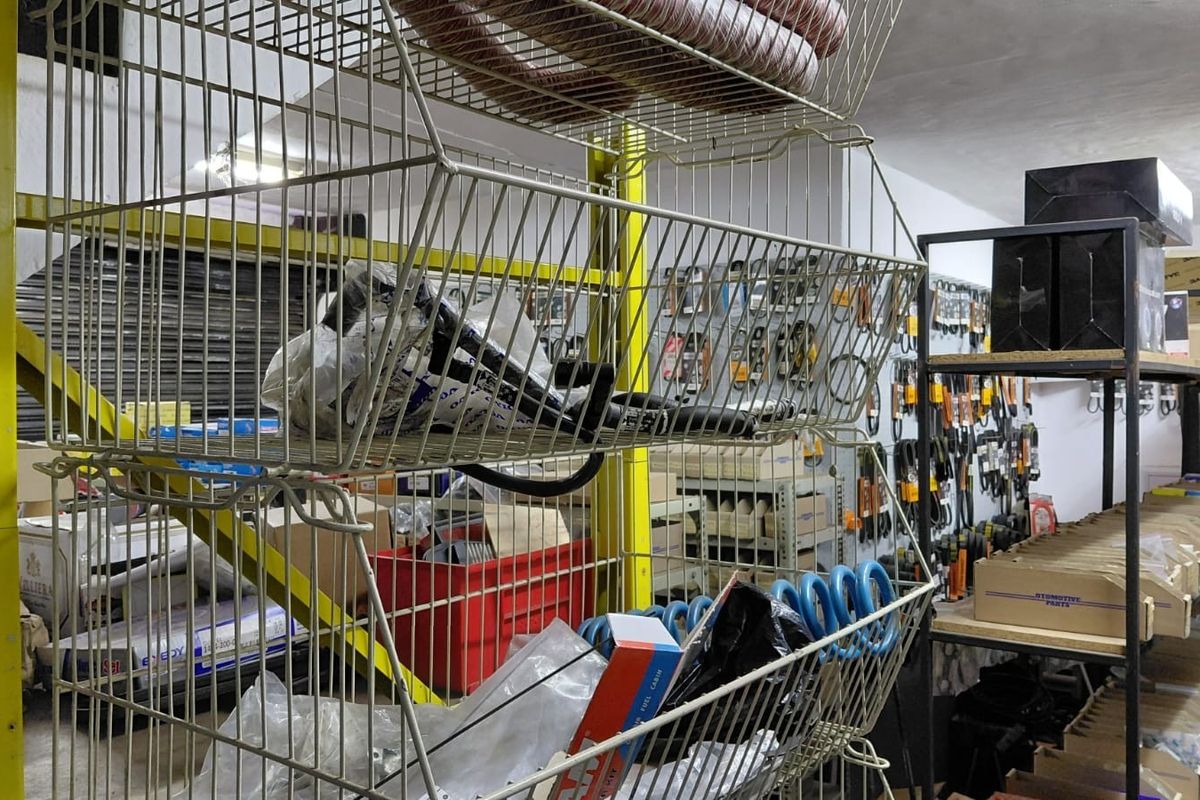A commercial utility or storage space featuring industrial metal shelving units and wall-mounted pegboard systems for organized inventory storage.