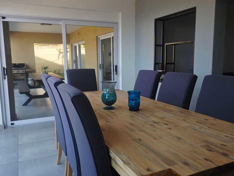 Dining area featuring tiled flooring and large sliding glass doors that provide seamless access to the outdoor patio space.