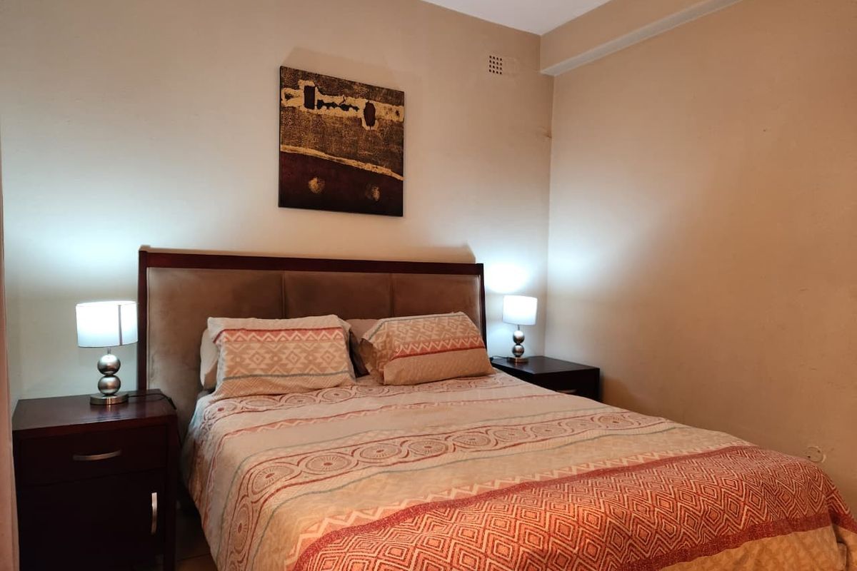 A standard bedroom featuring neutral wall tones and coving detail, providing a functional sleeping space with potential for cosmetic updates.