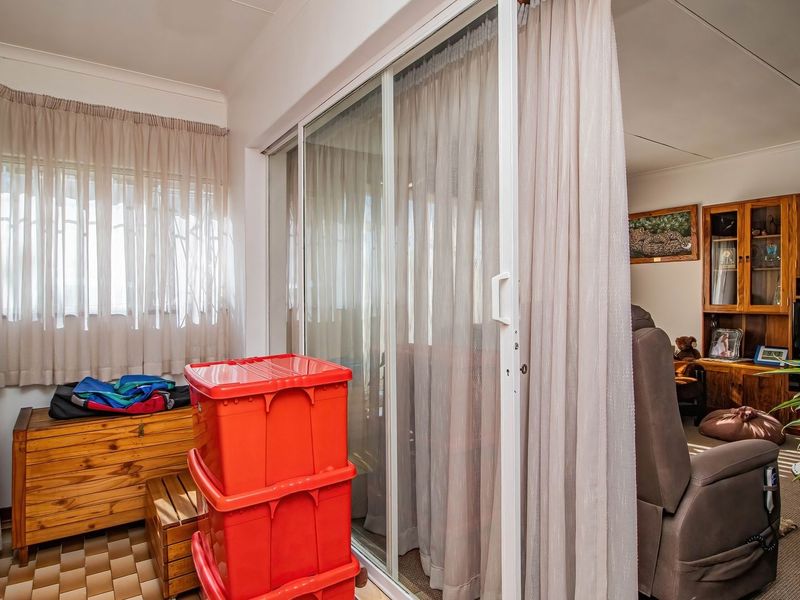 Enclosed patio area featuring sliding glass doors and tiled flooring, providing a transition space between the interior living area and the outdoors.