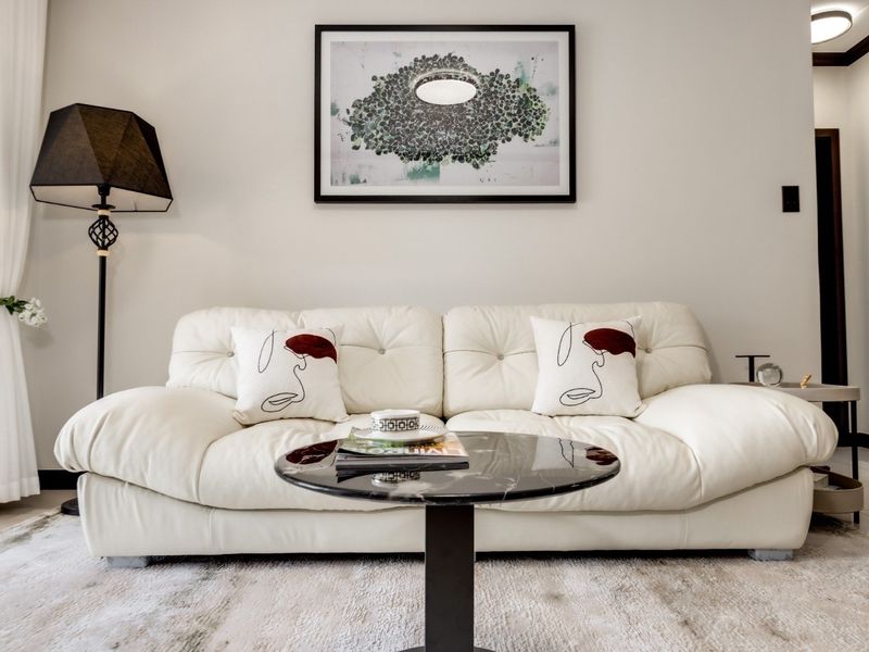 A well-maintained living room area featuring neutral wall finishes and clean architectural lines.