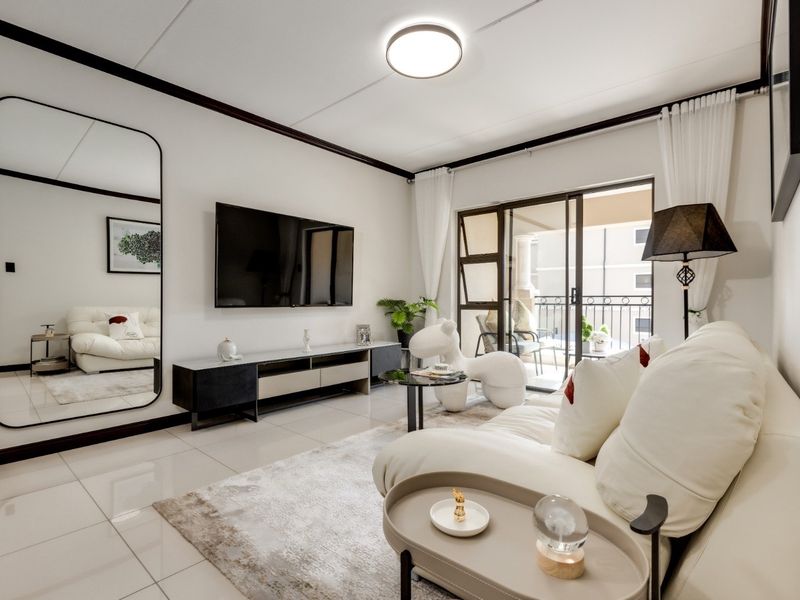 Modern living room featuring polished tiled flooring, clean white walls, and a sliding glass door providing access to a private balcony.