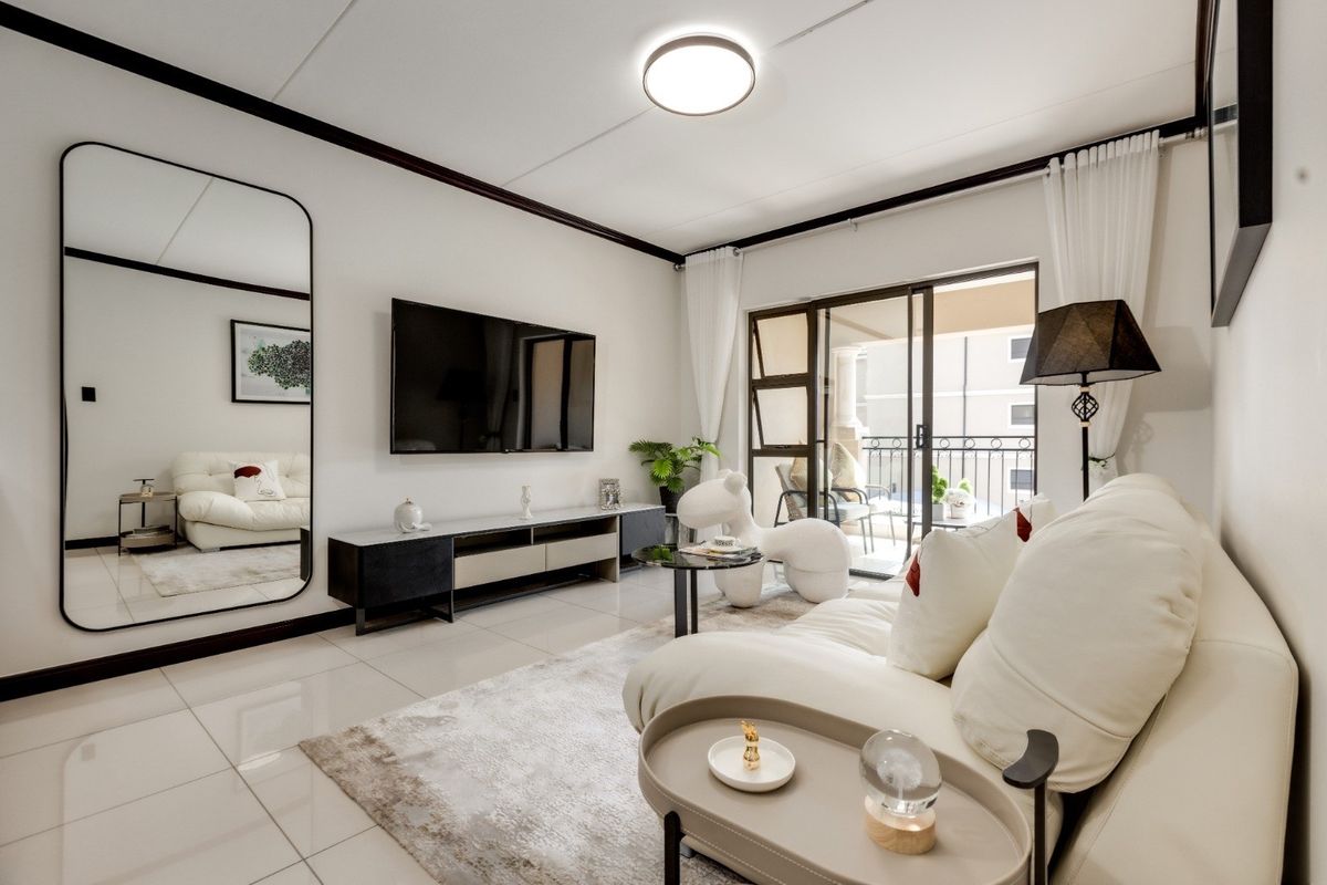 Modern living room featuring polished tiled flooring, clean white walls, and a sliding glass door providing access to a private balcony.