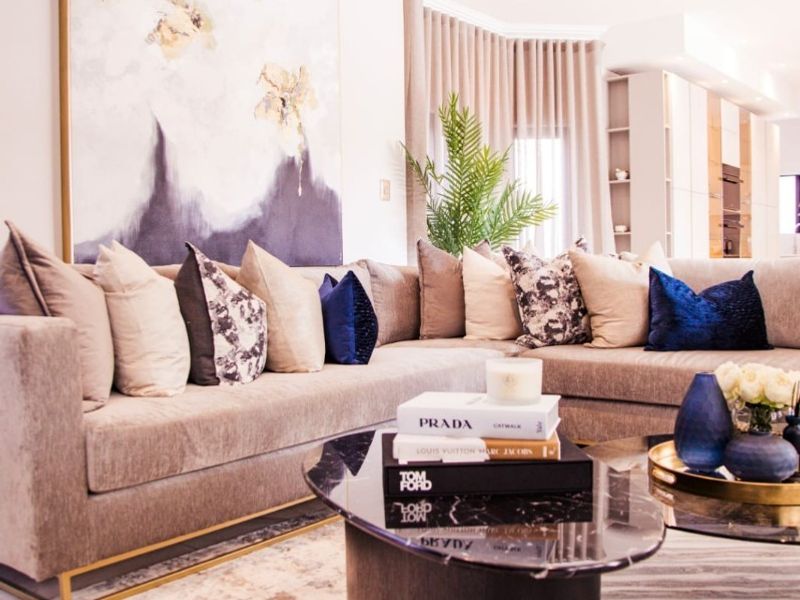 A well-appointed living room featuring recessed downlighting, elegant coving, and floor-to-ceiling curtain tracks, creating a sophisticated and polished atmosphere.