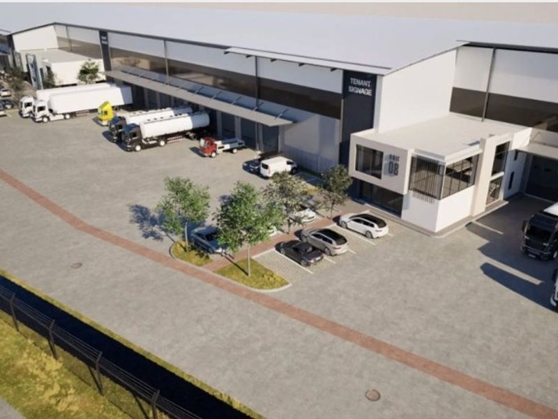 Aerial view of a modern industrial warehouse facility featuring extensive loading docks, paved yard space, and dedicated parking areas.