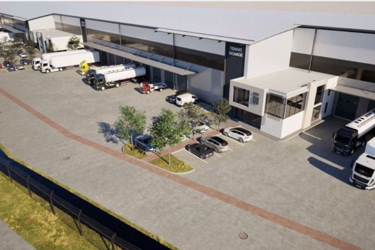 Aerial view of a modern industrial warehouse facility featuring extensive loading docks, paved yard space, and dedicated parking areas.