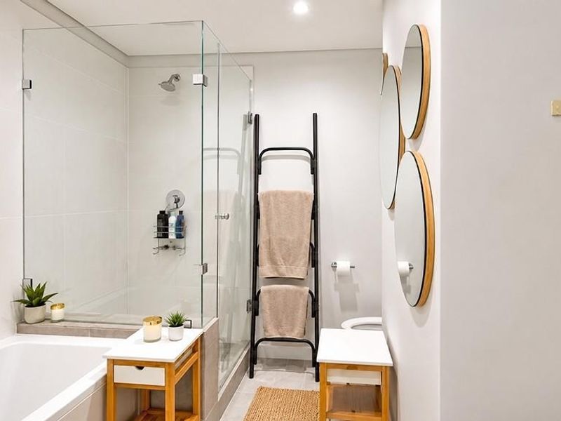 Modern bathroom featuring a glass-enclosed shower, built-in bathtub, and clean, neutral finishes throughout.