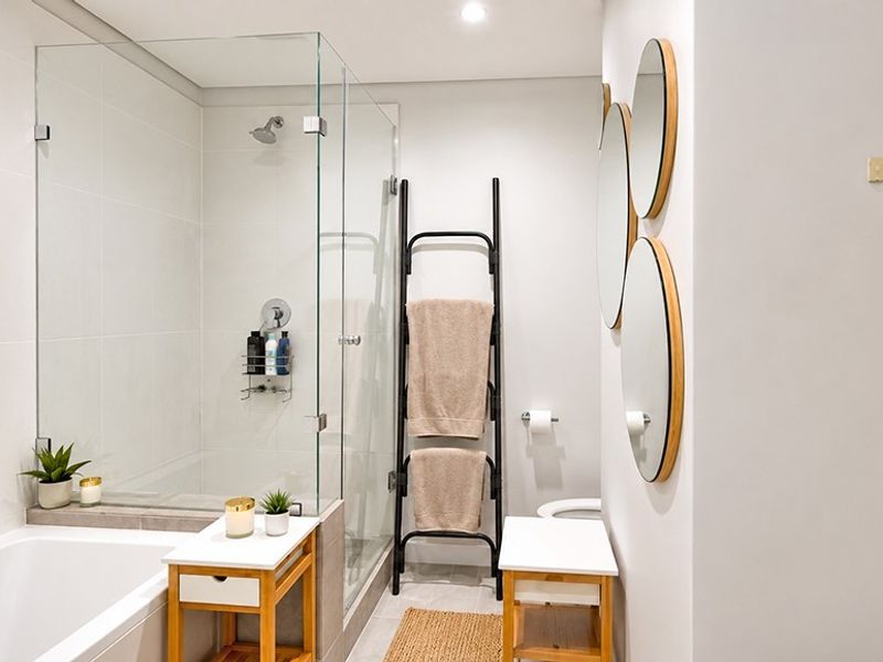Modern bathroom featuring a glass-enclosed shower, built-in bathtub, and clean, contemporary finishes throughout.