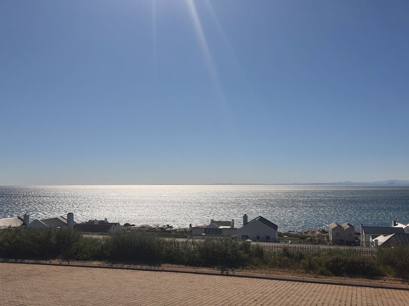 A scenic elevated view overlooking the ocean and coastal residential properties.