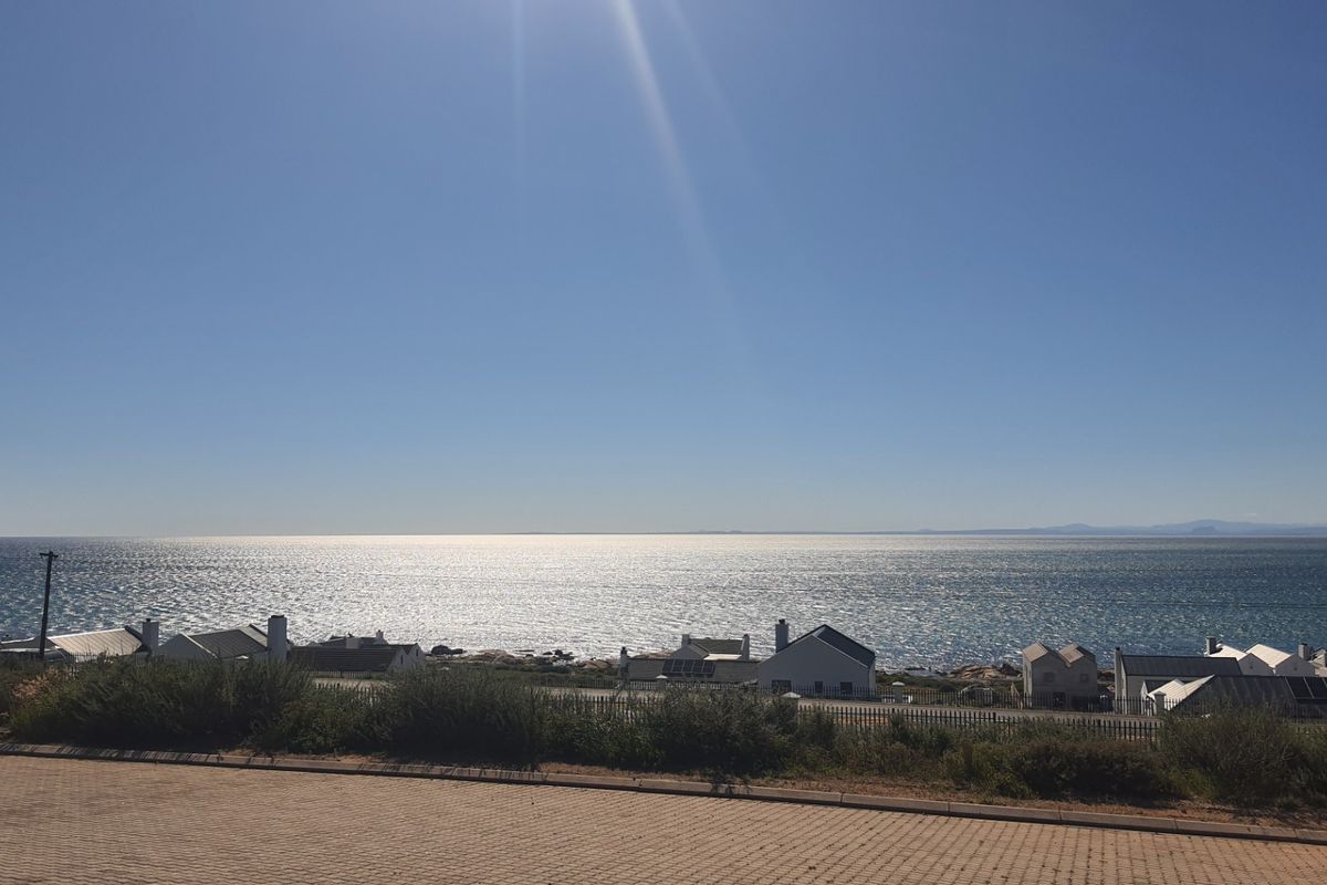 A scenic elevated view overlooking the ocean and coastal residential properties.