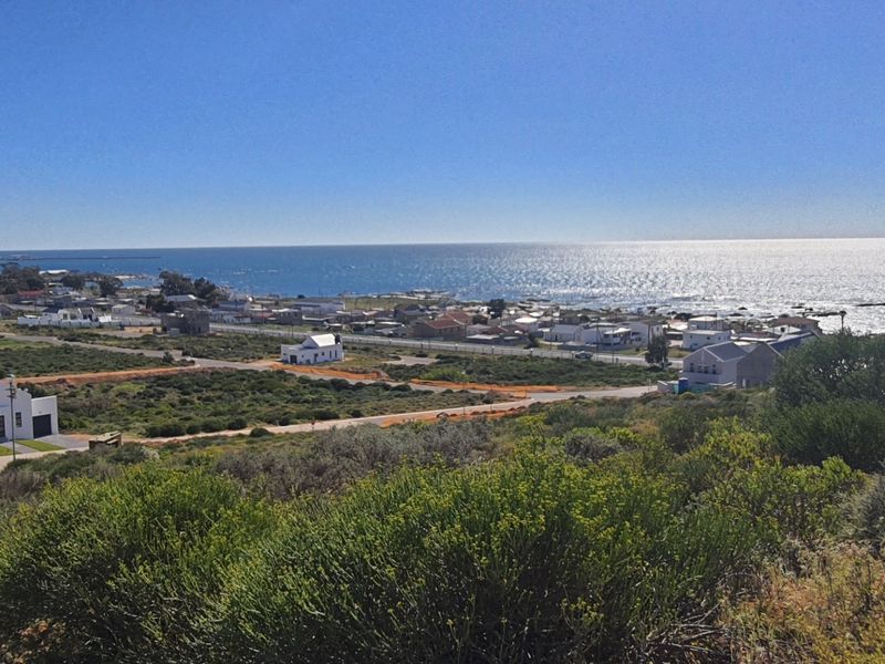 A scenic elevated view overlooking the coastal landscape, surrounding residential properties, and the ocean horizon.