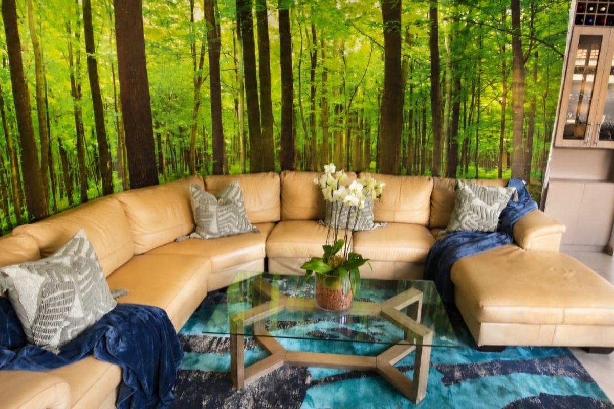 A living room featuring tiled flooring, built-in cabinetry, and a dedicated wine storage unit, accented by a forest-themed feature wall.