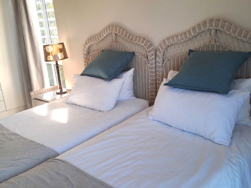 A well-maintained bedroom featuring a built-in wardrobe and natural light from the window.