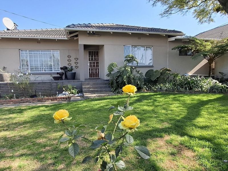 A well-maintained single-story residential home featuring a tiled roof, security-enhanced entrance, and a landscaped front garden with a paved driveway.