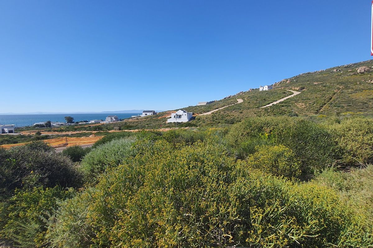 A scenic view of the coastal landscape and surrounding residential development, showcasing the natural terrain and proximity to the ocean.