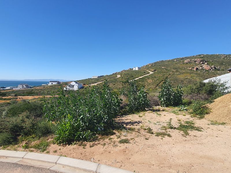 A scenic view of the coastal landscape and surrounding hillside, showcasing the natural terrain and proximity to the ocean.