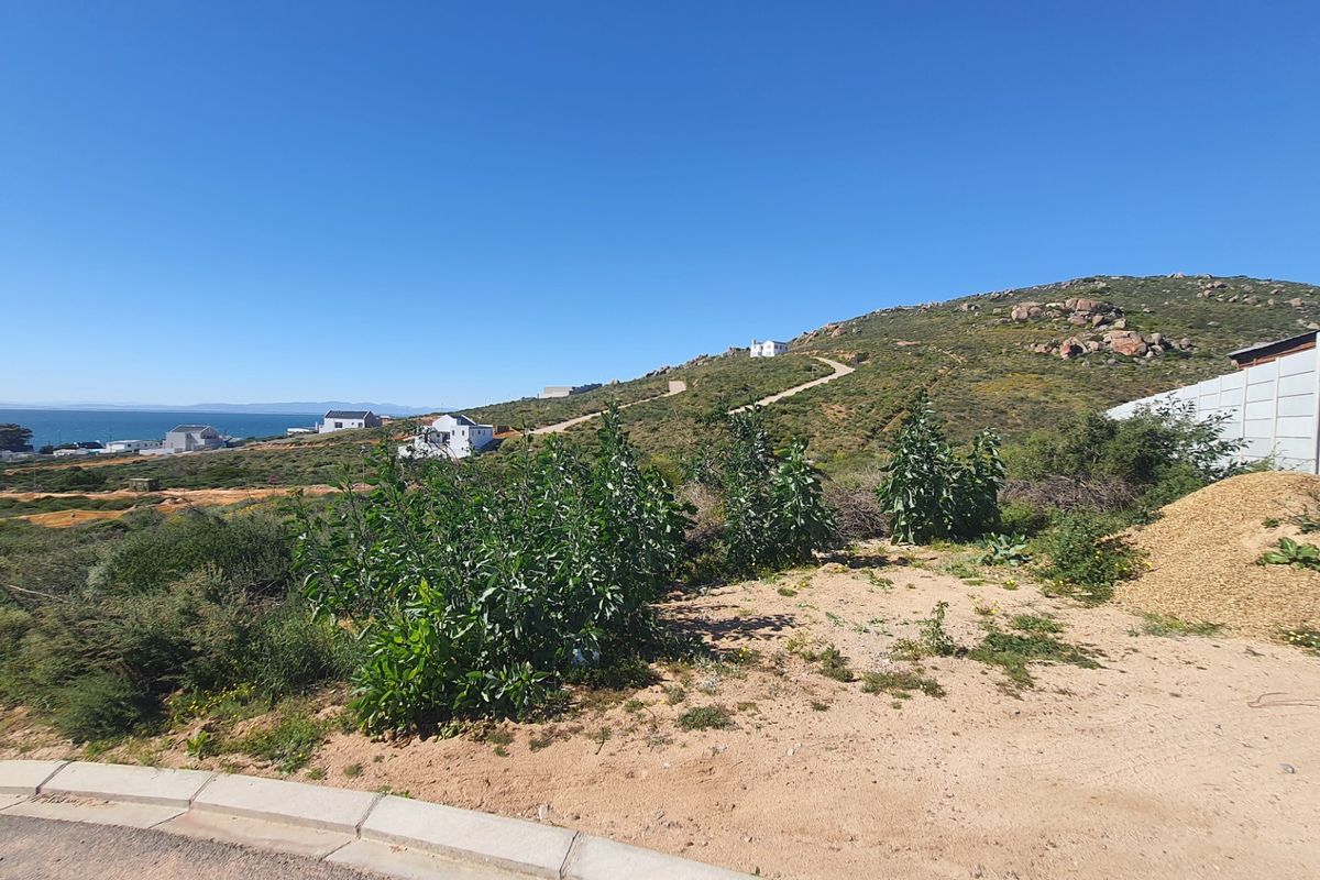 A scenic view of the coastal landscape and surrounding hillside, showcasing the natural terrain and proximity to the ocean.