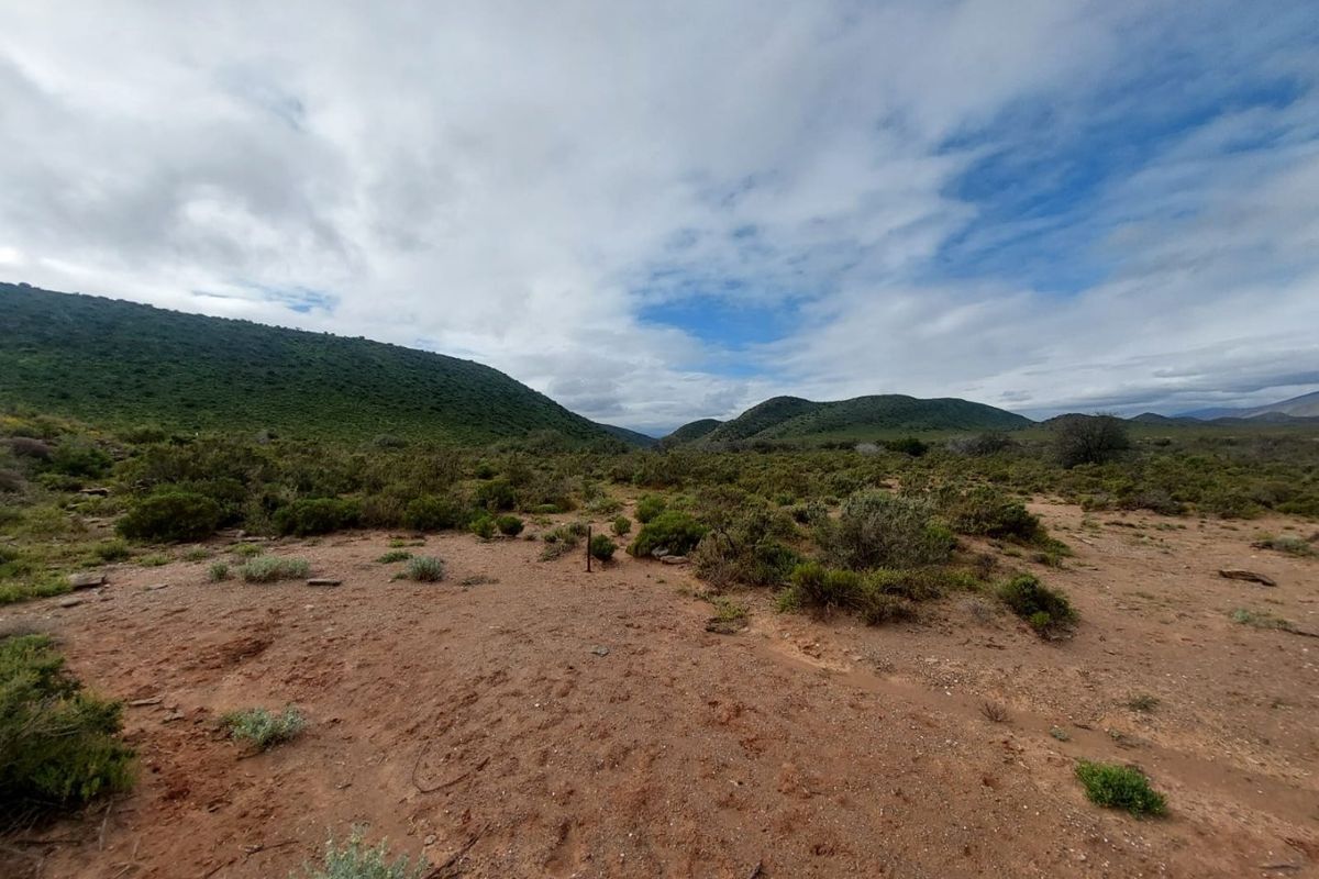 A wide-angle view of the expansive natural landscape and rolling hills characteristic of the farm property.