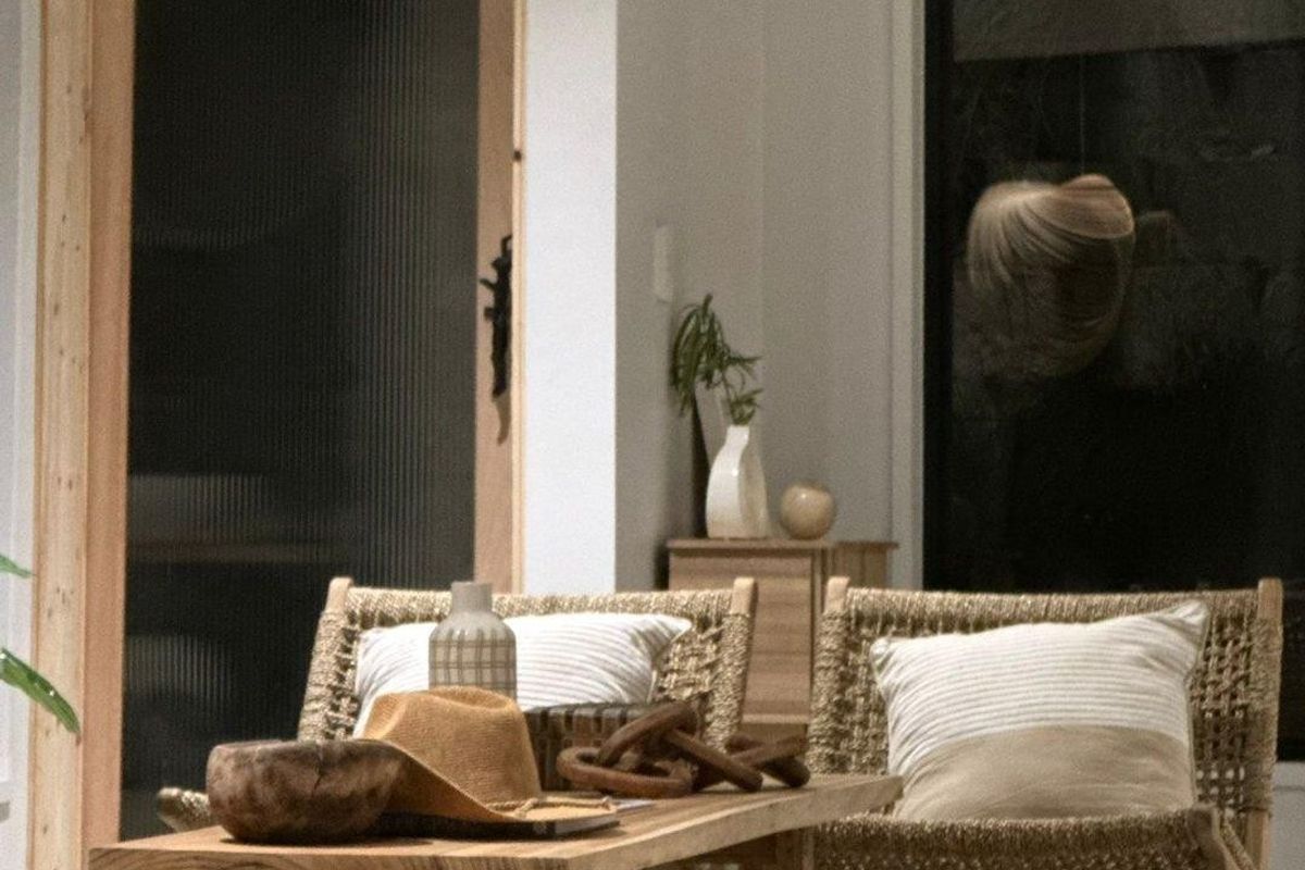 A modern living space featuring a stylish fluted glass door and a large black-framed window, creating a bright and contemporary atmosphere.