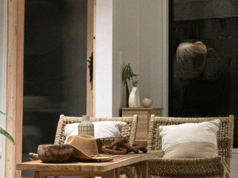 A modern living space featuring a stylish fluted glass door and a large black-framed window, creating a bright and contemporary atmosphere.